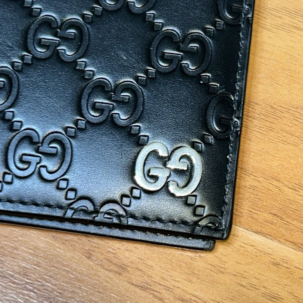 Authentic Gucci Dorian Signature Embossed Leather Bifold Wallet
